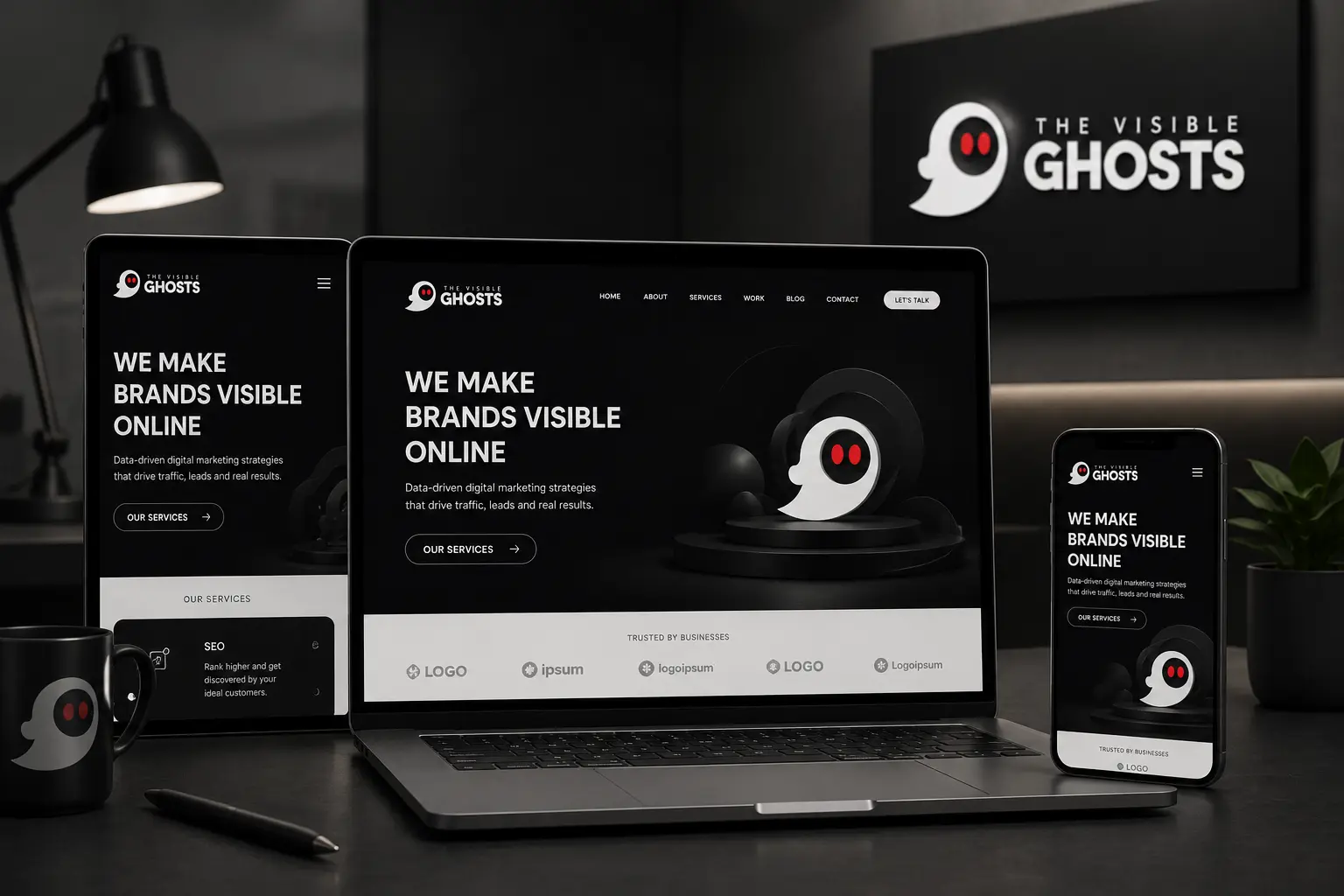 Creative studio desk setup with laptop displaying client website and branded smartphone